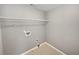A spacious laundry room includes a wire shelf for storage and washer-dryer hookups at 2708 Stockbridge Way, Dacula, GA 30019