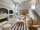 Bright living room featuring a fireplace, a large window, and stylish furniture at 2708 Stockbridge Way, Dacula, GA 30019