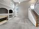 Bright living room featuring a fireplace, large window, and staircase at 2708 Stockbridge Way, Dacula, GA 30019