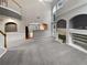 Spacious living room featuring high ceilings, fireplace, and archways to kitchen and other rooms at 2708 Stockbridge Way, Dacula, GA 30019
