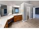 Main bathroom features tiled floors, double sink vanity, and entry to walk-in closet at 2708 Stockbridge Way, Dacula, GA 30019