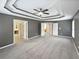 Spacious main bedroom with tray ceilings, a ceiling fan, and multiple closets at 2708 Stockbridge Way, Dacula, GA 30019