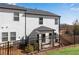 Exterior view of the back of a two-story townhome with a fenced yard and patio at 1733 Hyssop Blvd, Mableton, GA 30126