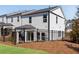 Back exterior of house with a fenced backyard, a patio, and green space behind at 1733 Hyssop Blvd, Mableton, GA 30126