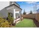 Green backyard with a covered porch and a retaining wall to level the yard at 1733 Hyssop Blvd, Mableton, GA 30126