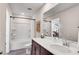 Bright bathroom with a combination tub and shower and a vanity with white countertop and dark wood cabinets at 1733 Hyssop Blvd, Mableton, GA 30126