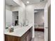 Bathroom features a dark wood vanity with white countertop, a large mirror, and access to the bedroom at 1733 Hyssop Blvd, Mableton, GA 30126