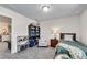 Cozy bedroom features plush carpet, a comfortable chair, and ample storage with a bookshelf and small book rack at 1733 Hyssop Blvd, Mableton, GA 30126