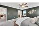 Comfortable bedroom with a ceiling fan, a relaxing chair by the window, and neutral walls at 1733 Hyssop Blvd, Mableton, GA 30126