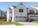 Charming two-story home featuring a white brick facade and a two-car garage at 1733 Hyssop Blvd, Mableton, GA 30126