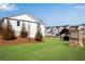 View of the community entrance with lush lawns and multiple townhome units at 1733 Hyssop Blvd, Mableton, GA 30126