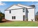 Modern townhome with a white brick facade, black trim, and a lush green lawn at 1733 Hyssop Blvd, Mableton, GA 30126