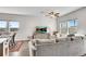 Bright living room features a ceiling fan, large windows and comfortable seating at 1733 Hyssop Blvd, Mableton, GA 30126