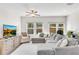 Cozy living room with a plush sectional sofa, ceiling fan, and abundant natural light at 1733 Hyssop Blvd, Mableton, GA 30126