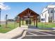 Community mailboxes under a wood shelter with parking and landscaping at 1733 Hyssop Blvd, Mableton, GA 30126