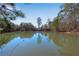 Scenic pond surrounded by mature trees and nearby residences in view at 1733 Hyssop Blvd, Mableton, GA 30126