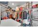 Well-organized walk-in closet with shelving, hanging racks and a white folding table at 1733 Hyssop Blvd, Mableton, GA 30126