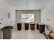 Resident storage area featuring tile flooring, a window, and multiple trashcans for proper waste disposal at 6851 Roswell Rd # H1, Sandy Springs, GA 30328