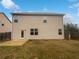 View of a backyard showing the home's siding, door to the exterior and small patio area at 1260 Brookstone Cir, Conyers, GA 30012