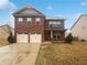 Charming two-story brick home with a two-car garage and well-maintained front yard at 1260 Brookstone Cir, Conyers, GA 30012