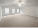 Spacious, bright living room featuring vaulted ceilings, a ceiling fan, and neutral carpeting at 1260 Brookstone Cir, Conyers, GA 30012