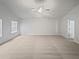 Large, open living room with natural light, neutral carpet and a ceiling fan at 1260 Brookstone Cir, Conyers, GA 30012