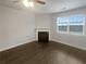 Cozy living room featuring a classic fireplace and a window with natural light at 1260 Brookstone Cir, Conyers, GA 30012
