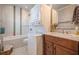 Bathroom featuring decorative tile and a modern sink with a stacked washer and dryer at 1269 Monroe Drive Ne, Atlanta, GA 30306