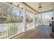 Spacious front porch with wood floors and white railings offering a great view of the neighborhood at 1269 Monroe Drive Ne, Atlanta, GA 30306