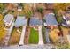 Aerial view of three charming homes with well-maintained lawns, mature trees, and private driveways at 2026 Swazey Dr, Decatur, GA 30032