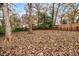 Leafy backyard featuring mature trees and a wooden fence at 2026 Swazey Dr, Decatur, GA 30032