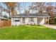 Charming single-story home featuring a painted brick facade, well-manicured lawn, and a private driveway at 2026 Swazey Dr, Decatur, GA 30032