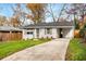 Charming single-story home featuring a painted brick facade, well-manicured lawn, and a private driveway at 2026 Swazey Dr, Decatur, GA 30032