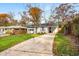 Home with lush green front lawn and concrete driveway at 2026 Swazey Dr, Decatur, GA 30032