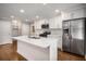 Open kitchen features white cabinets, stainless steel appliances, and marble countertop island at 2026 Swazey Dr, Decatur, GA 30032