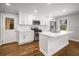 Well-lit kitchen featuring a center island, stainless steel appliances, and white cabinetry at 2026 Swazey Dr, Decatur, GA 30032