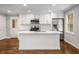 Bright kitchen with white cabinets, stainless steel appliances, and a large center island at 2026 Swazey Dr, Decatur, GA 30032
