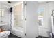 Bathroom with a sink, toilet, shower/tub combo, and a window for natural light at 207 Taylor Cir, Palmetto, GA 30268