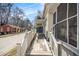 Side view of a yellow one story house featuring a wooden ramp and screened-in porch at 207 Taylor Cir, Palmetto, GA 30268