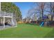 Wide shot of the backyard, showing the deck, playset and grassy area at 340 Willow Crescent Way, Johns Creek, GA 30022