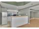 Basement kitchenette features a bar counter, white cabinets, and a green tiled backsplash at 340 Willow Crescent Way, Johns Creek, GA 30022