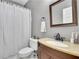 Cozy bathroom showcasing a vanity with solid countertops and a shower with white shower curtain at 340 Willow Crescent Way, Johns Creek, GA 30022