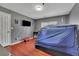 Neutral bedroom with hardwood floors, a tent over a bed, and mounted flat screen TV at 340 Willow Crescent Way, Johns Creek, GA 30022