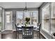 Bright dining area with large windows offering views, complete with a modern table and chairs at 340 Willow Crescent Way, Johns Creek, GA 30022
