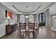 Elegant dining room features a tray ceiling, hardwood floors, and a view of the arched double doors at 340 Willow Crescent Way, Johns Creek, GA 30022