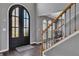Spacious entryway featuring a wooden staircase, iron railing, and arched double doors at 340 Willow Crescent Way, Johns Creek, GA 30022