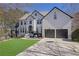Attractive two-story home featuring a brick facade, well-manicured lawn, and a two-car garage at 340 Willow Crescent Way, Johns Creek, GA 30022