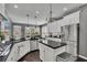 Gourmet kitchen with white cabinets, stainless steel appliances, a central island, and dark countertops at 340 Willow Crescent Way, Johns Creek, GA 30022