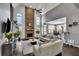Open-concept living room with high ceilings, a stone fireplace, and views of the kitchen at 340 Willow Crescent Way, Johns Creek, GA 30022