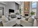 Living room with a stone fireplace, hardwood floors, large windows and comfortable furnishings at 340 Willow Crescent Way, Johns Creek, GA 30022